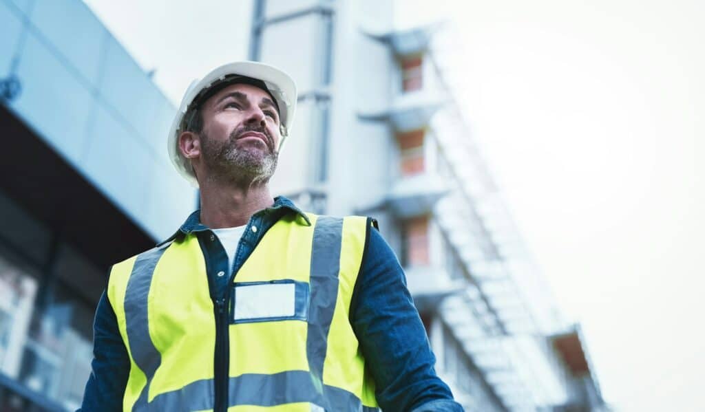 Hire the best architect in town. Shot of a engineer standing in front of a building.